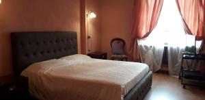 a bedroom with a bed and a window at La Martinella in Canelli