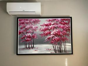 a painting of trees with pink flowers on a wall at Castello Guest House, Bloemfontein in Bloemfontein
