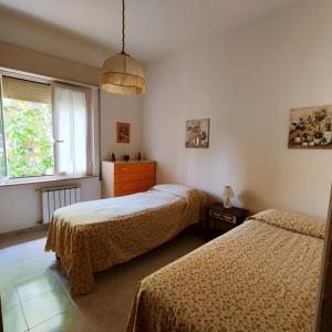 Monte Rubiaglio的住宿－Civico 5，一间卧室设有两张床和窗户。