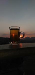 a cup of tea on a table with the sunset in the background at شقه فندقيه.Apartment,Petra in Wadi Musa