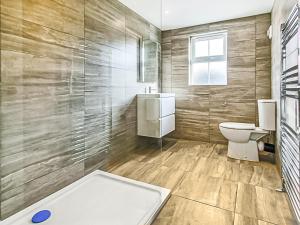 a bathroom with a toilet and a sink at Sahara Rose in East Grinstead