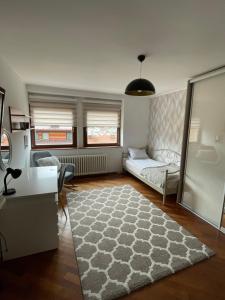 a living room with a couch and a rug at Deluxe Apartment Lejla - Free garage parking in Sarajevo