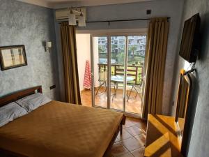 a bedroom with a bed and a view of a balcony at Mirador Golf Appart-hotel in Cabo Negro