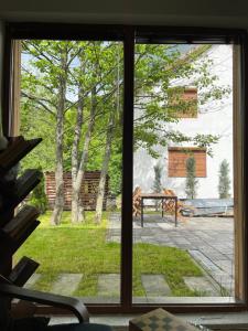 a window view of a yard with a patio at Villa Alpina Brezovice in Brezovicë