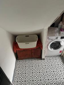 a small room with a washing machine and a floor at Room in new flat in Walsall