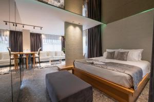 a bedroom with a bed and a dining room at Wolf Suites in Antalya