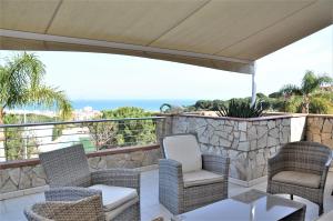 a patio with two chairs and an umbrella at VILLA SOFIA CALELLA in Calella