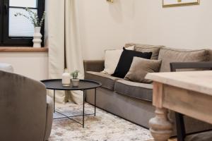 a living room with a couch and a table at Boutique Vaksali Apartment in Viljandi +19 photos
