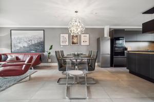 a kitchen and living room with a table and chairs at - DESIGN & STYLE - Modern House with terrace & garden in Wesel