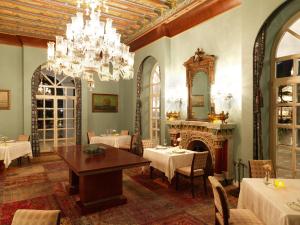 a dining room with a fireplace and a chandelier at La Maison Bleue El Gouna in Hurghada
