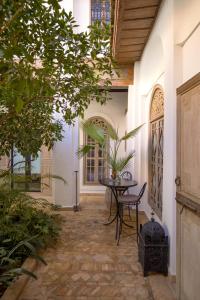 a courtyard of a house with a table and chairs at Riad Les Hirondelles Boutique Hotel in Marrakech