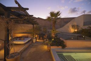 a patio with a bed and a swimming pool at Riad Les Hirondelles Boutique Hotel and Spa in Marrakesh