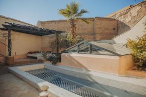 a swimming pool in the middle of a house at Riad Les Hirondelles Boutique Hotel in Marrakech