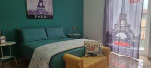 a bedroom with a bed and a chair and the eiffel tower at CASADEI24 in Guidonia