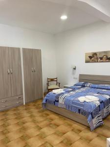 a bedroom with a bed and a chair in it at The Gods Brothers in Agerola