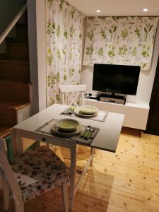 a dining room with a table and a television at Il Bagolaro in Feriole +15 photos