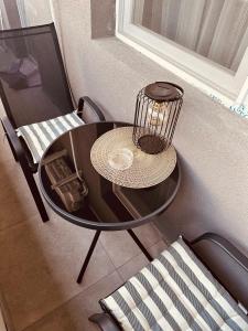 a table and chairs with a bird cage on it at A&Y APARTAMENT in Floreşti