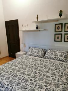 a bedroom with a bed with a black and white comforter at Il Bagolaro in Feriole