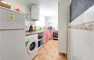 a kitchen with a washer and dryer in a room at 3 Bedroom Cozy Apartment In Gandia in Gandía