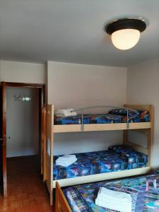a room with two bunk beds and a light at CIVICO 43 in Chiesa in Valmalenco