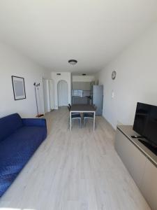 a living room with a blue couch and a table at Appartamenti Elisabeth in Brenzone sul Garda