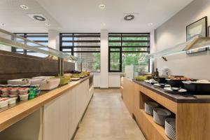 a large kitchen with a buffet line of food at Super 8 by Wyndham Koblenz in Koblenz