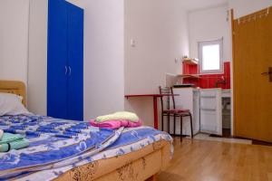 a bedroom with a bed and a blue door at Villa Horizon Canj in Čanj +149 photos