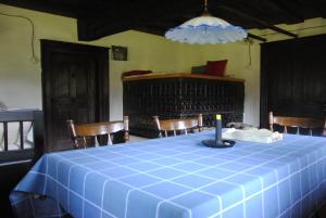 a blue table with chairs and a candle on it at Hiša 1820 in Žiri