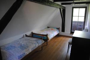 a bedroom with two beds in a attic at Hiša 1820 in Žiri