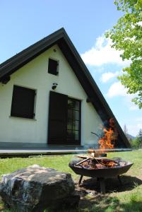 a fire pit in front of a house at Hiša 1820 in Žiri