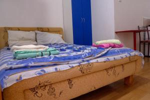 a bed with towels on it with a blue door at Villa Horizon Canj in Čanj
