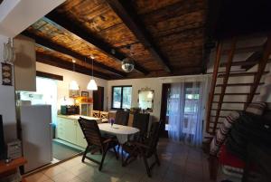 a kitchen and dining room with a table and chairs at Holiday House River Mrežnica in Duga Resa