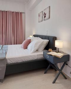 a bedroom with a bed and a table with a lamp at Harmony home in Ierápetra