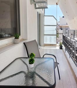 a table and chairs on a balcony with a window at Harmony home in Ierápetra