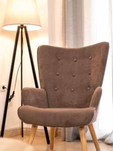 a brown chair sitting next to a lamp at Harmony home in Ierápetra