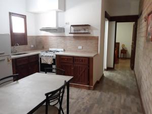 a kitchen with a table and a stove top oven at Departamento Cafayate in Cafayate