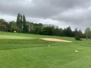 a view of a golf course with a green at Bener'Inn Au calme Une maison 3 chambres 125 m2 ou Une maison 2 chambres 50 m2 ou les 2 maisons in Bénerville-sur-Mer