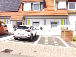 a white car parked in front of a house at Ferienwohnung in Porta Westfalica