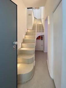 a stairway in a building with a white staircase at WePuglia - Al Castello di AMEC - Apt Marika in Monopoli