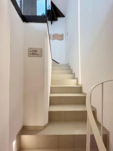 a staircase in a house with white walls at WePuglia - Al Castello di AMEC - Apt Marika in Monopoli