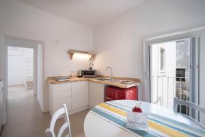 a small kitchen with a table and a microwave at WePuglia - Al Castello di AMEC - Apt Marika in Monopoli