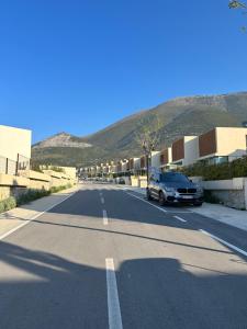 a black car parked on the side of a street at Getaway Room Palase in Palasë