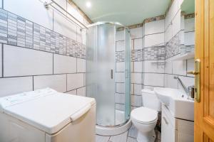 a bathroom with a toilet and a sink and a shower at Georgios House in Skala Marion