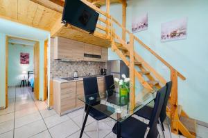 a kitchen and dining room with a glass table with chairs at Georgios House in Skala Marion +12 photos