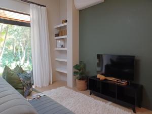 a living room with a couch and a flat screen tv at Eggersheim in Pinetown