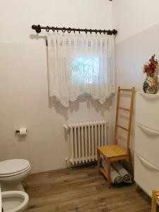 a bathroom with a toilet and a window at Il Bagolaro in Feriole