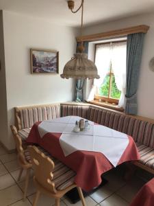 comedor con mesa y sofá en Gästehaus Schwarzlofer, en Reit im Winkl