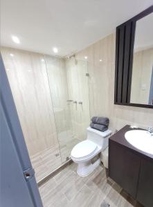 a bathroom with a shower and a toilet and a sink at Hotel El Arroyo in Caracas