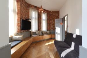 a living room with a couch and a tv at Central Apartamenty in Jelenia Góra