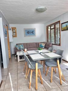 a dining room with a table and chairs and a couch at 81 Kingfisher in Lake Marina